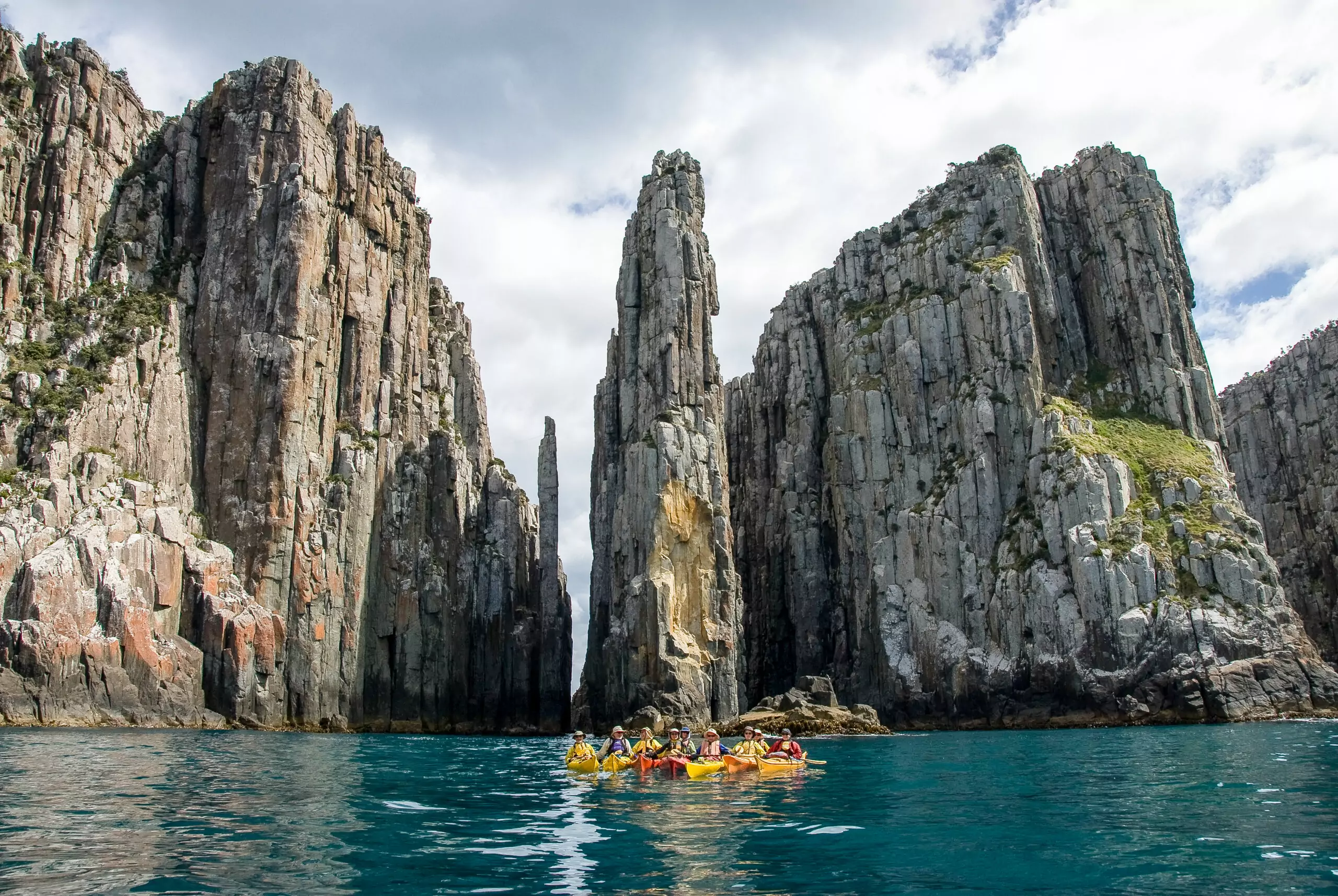 group of kayakers near incredible rock formation